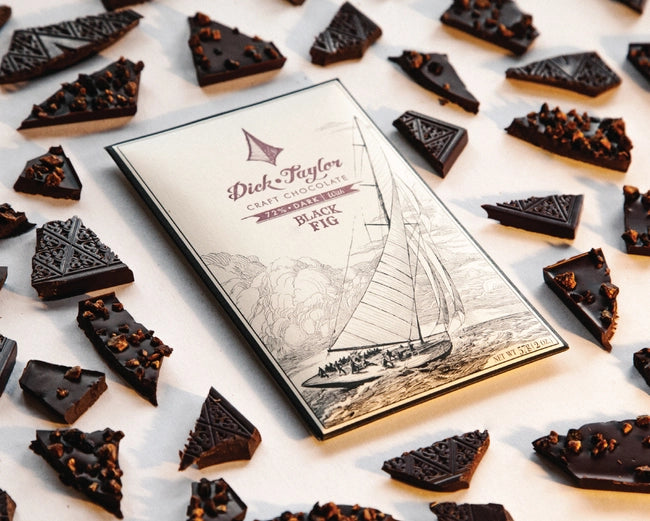Chocolate bars with a 'Dick Taylor' packaging featuring a sailboat illustration on a light background.