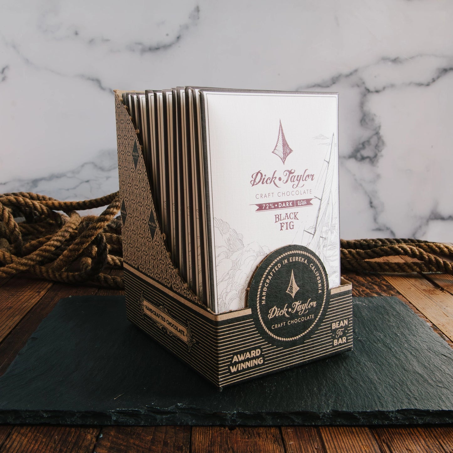 Dick Taylor craft chocolate packaging on a marble background