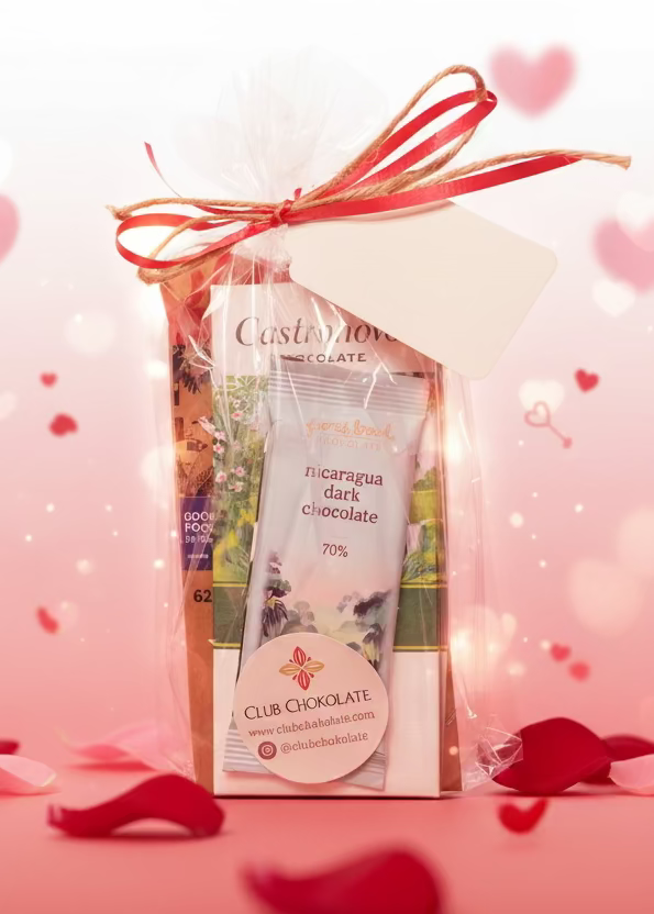 Gift package with Club Chocolat chocolate bar and a tag on a wooden surface