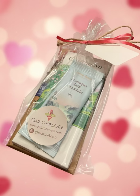 Club Chocolat chocolate bar in clear packaging on a wooden surface
